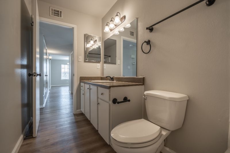 bethroom with white cabinets and granite countertop