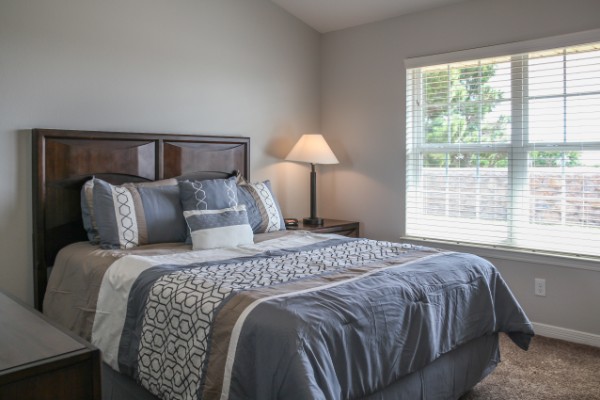 decorated bedroom with carpeting and a large window