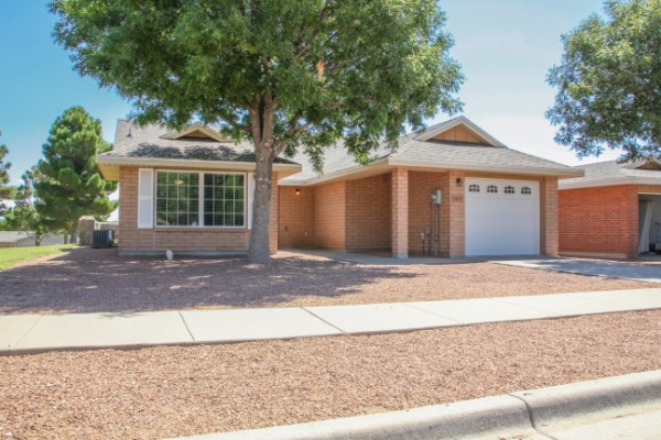 exterior of home front with a tree out front and a walkway